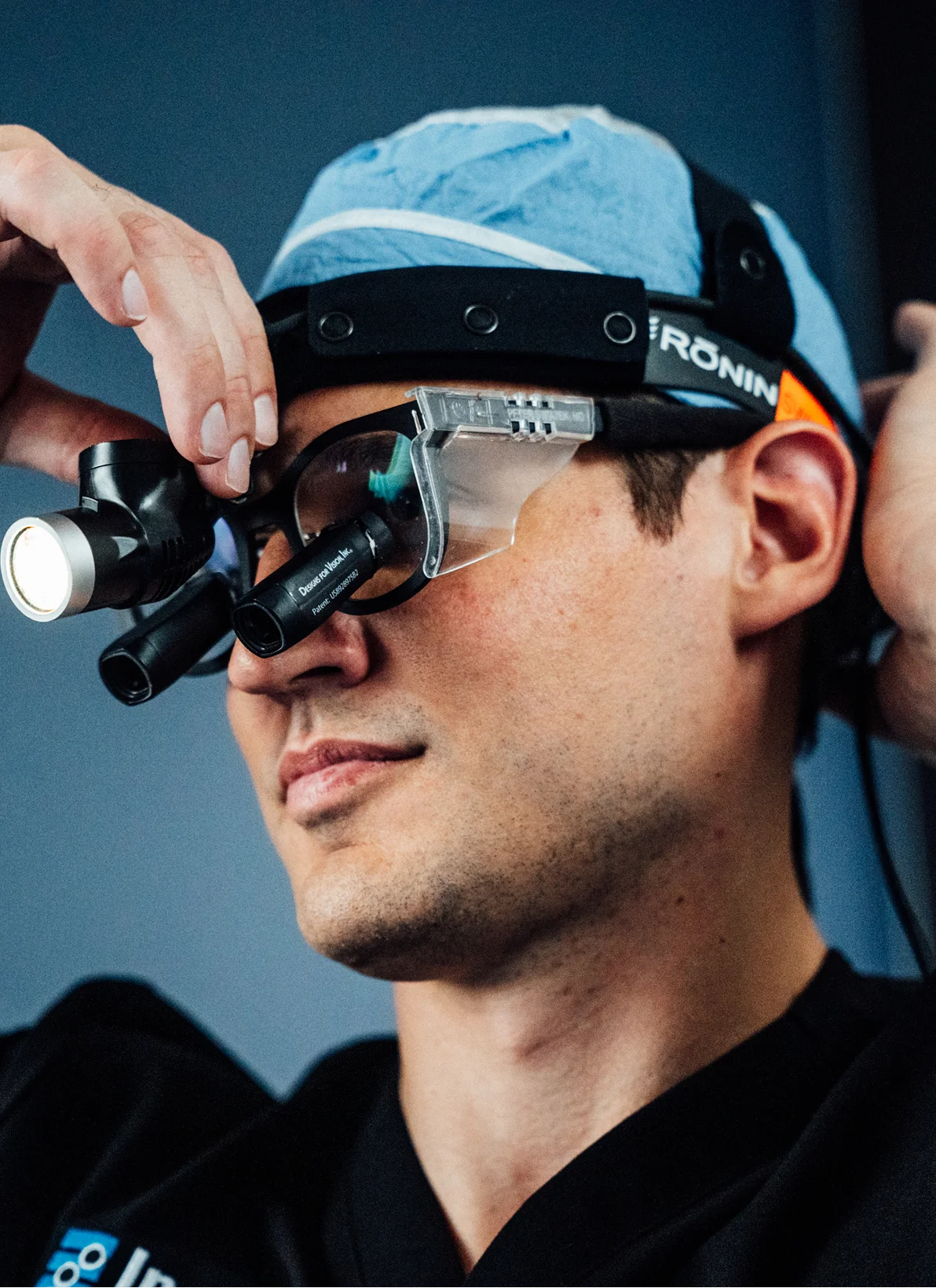 Dr Peter Swiatek wearing surgical loupes with LED headlight for precision medical procedures - in Carmel, IN